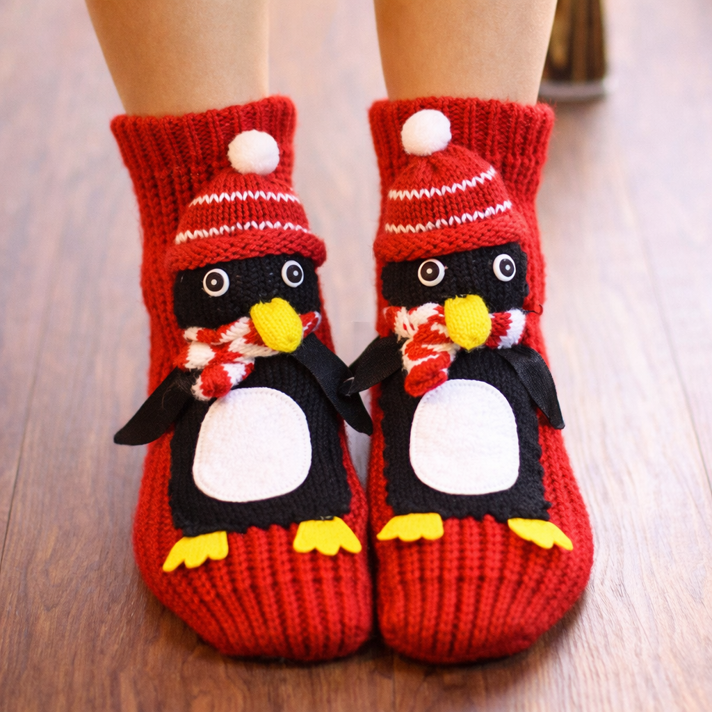 Red penguin-themed socks on a wooden floor
