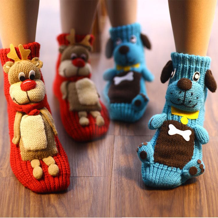 Knitted socks with animal designs on a wooden floor